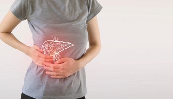 A woman painfully grabs the liver region in the white background.