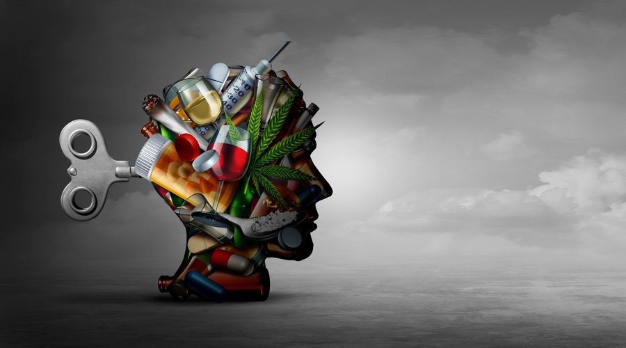 Ritratto di una testa umana in posizione laterale, composta da sostanze che creano dipendenza come droghe, una pianta di cannabis, ecc. 