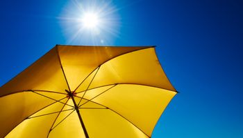 Yellow parasol with blue sky
